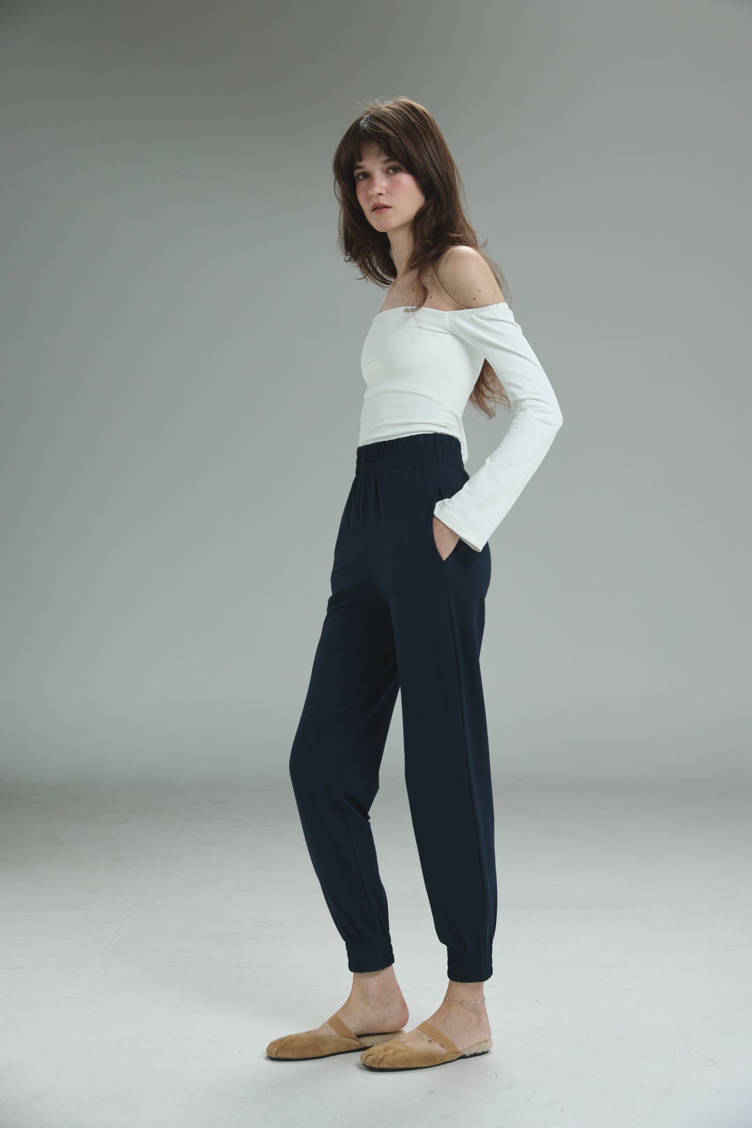 Navy high-waisted jogger pants with elastic cuffs and side pockets shown from the front in bestie navy joggers style