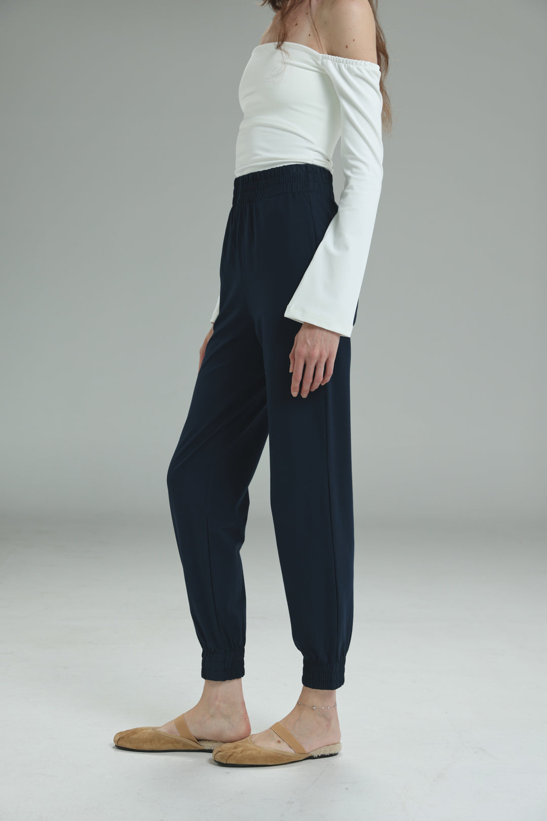Navy blue high-waisted jogger pants with elastic cuffs shown from the front in the bestie navy joggers style