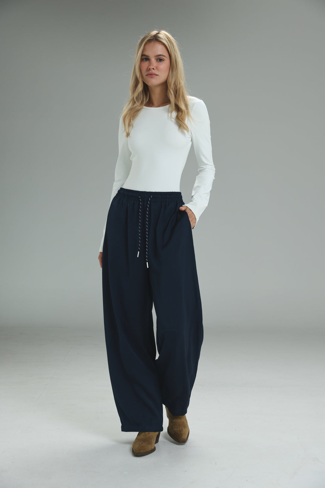 Navy blue wide-leg golden navy bottoms with a drawstring waist and subtle side pockets shown from the front