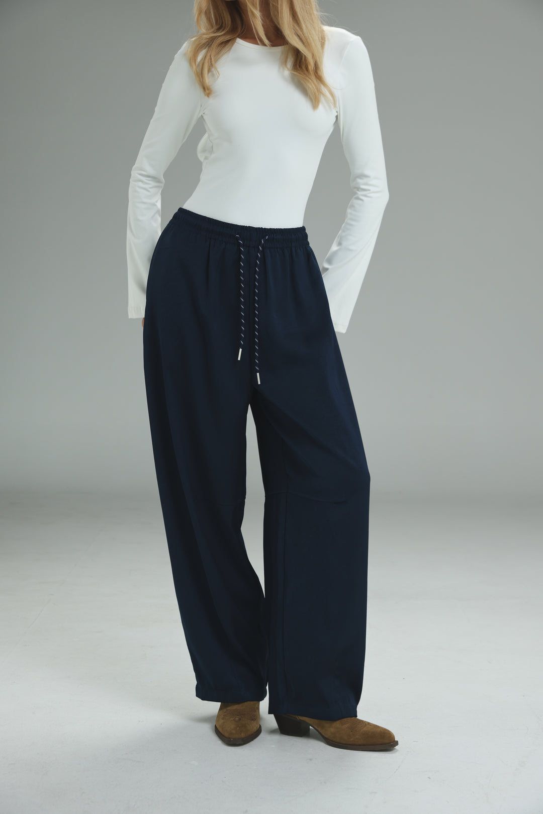 Navy blue wide-leg Golden Navy bottoms with drawstring waist and subtle pleats shown from the front