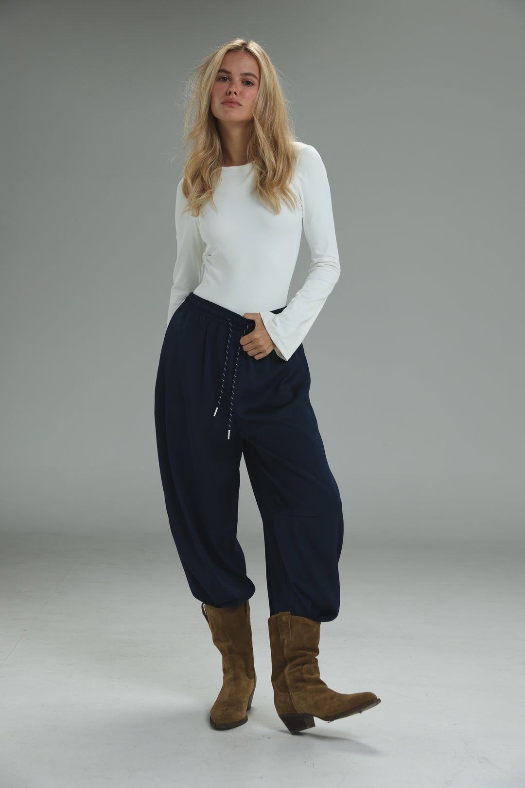 Navy blue drawstring pants with relaxed tapered fit shown from the front in golden navy bottoms product image