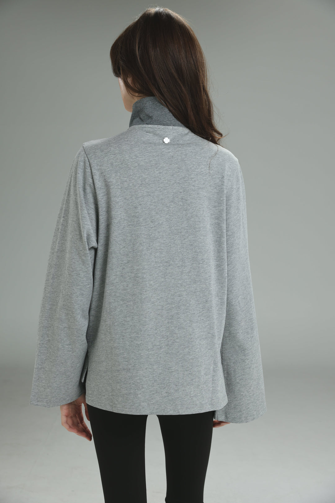 Gray heathered long-sleeved top with high collar and subtle button detail at the neckline front view