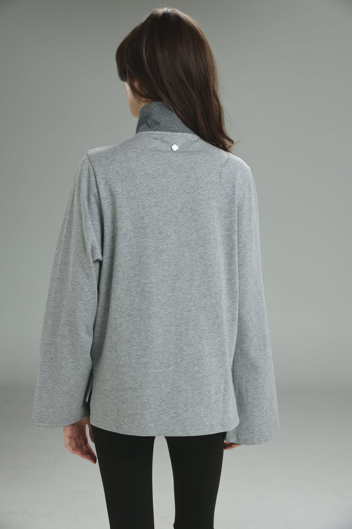Gray heathered long-sleeved top with high collar and subtle button detail at the neckline front view
