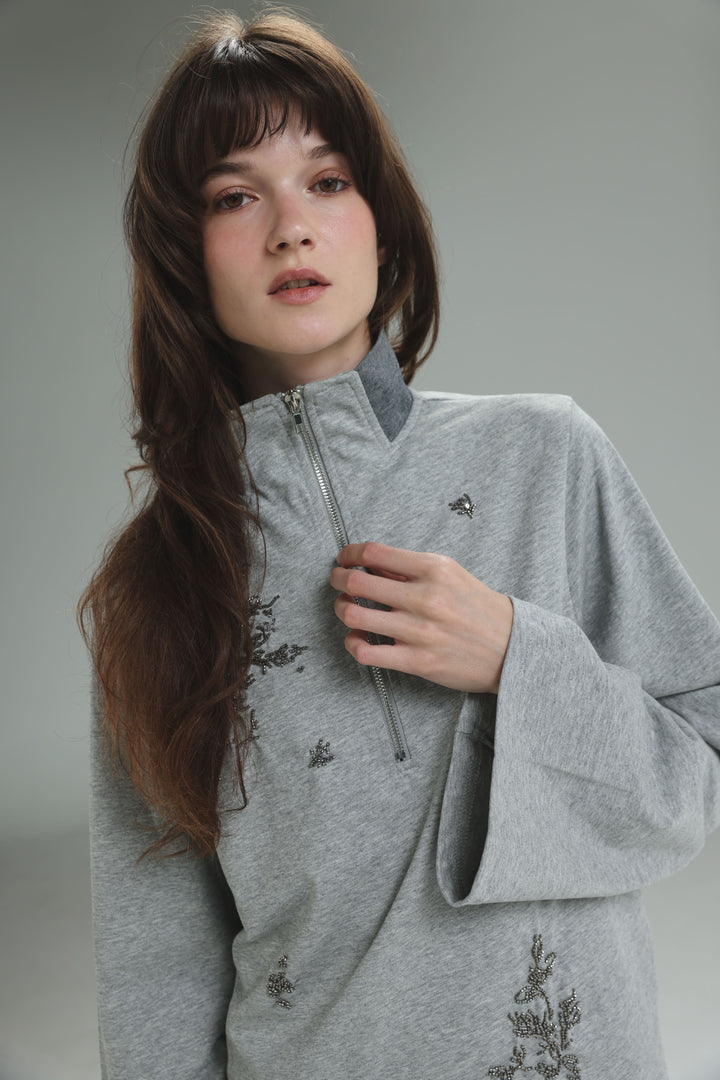 Joy grey polo sweatshirt with black embroidered floral patterns and front zipper shown from the front view