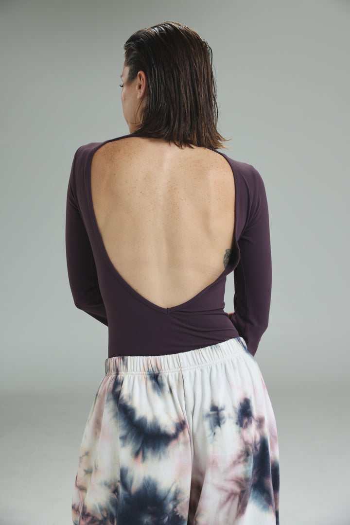 Lycra purple long-sleeved bodysuit with a wide open back design shown from the back view