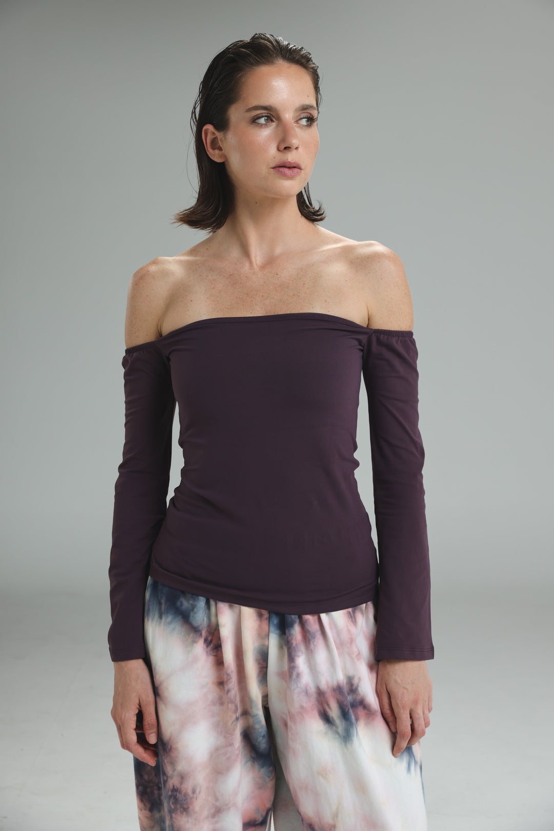 Lycra purple off shoulder top with long sleeves in deep plum shown from the front