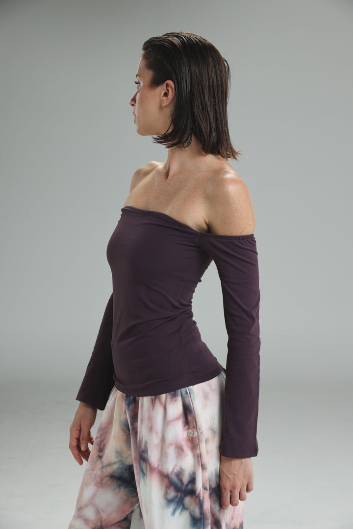 Dark purple lycra off shoulder top with long sleeves fitted silhouette and subtle ruching at the neckline front view