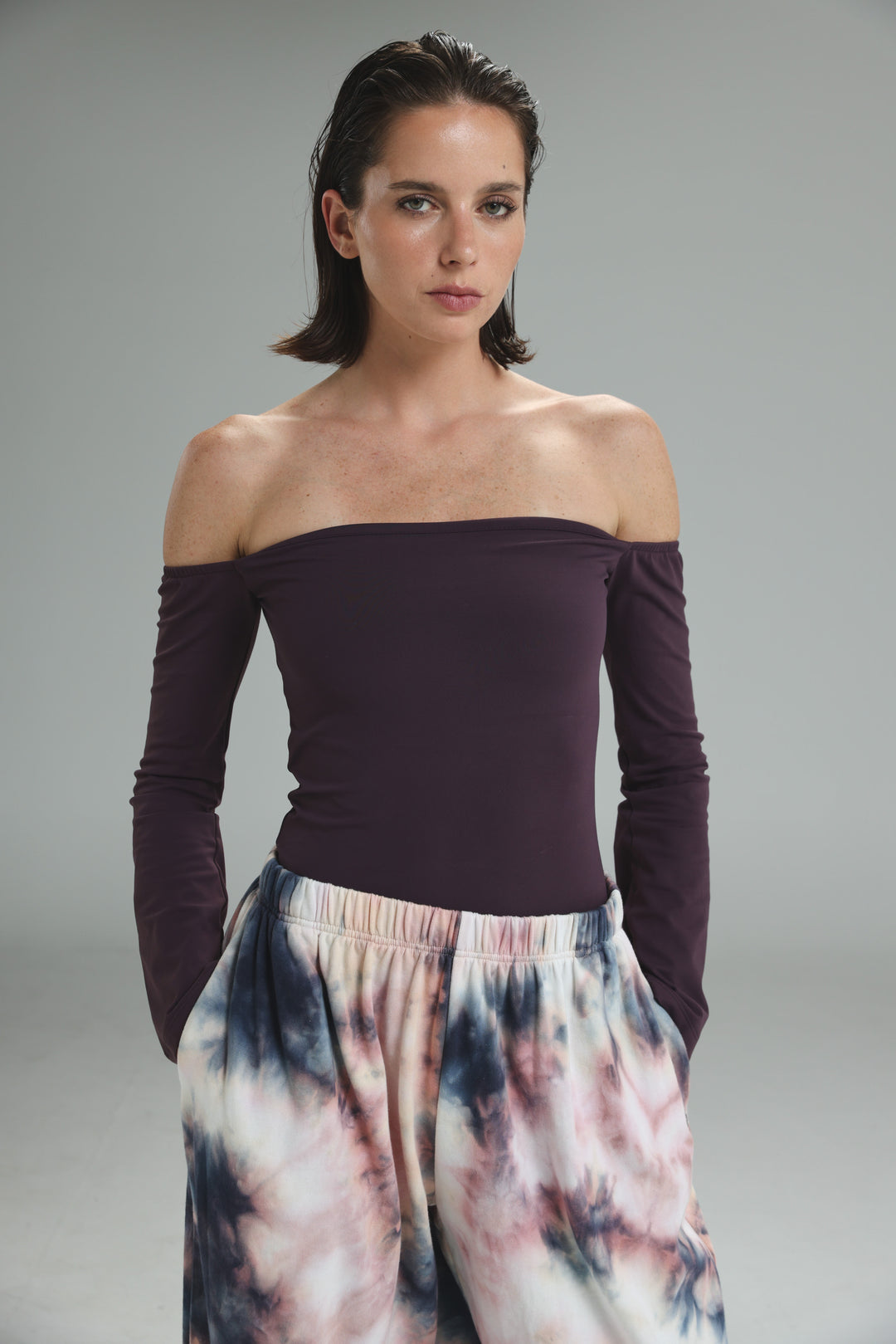 A deep purple lycra off-the-shoulder top with long sleeves and a smooth, form-fitting front view