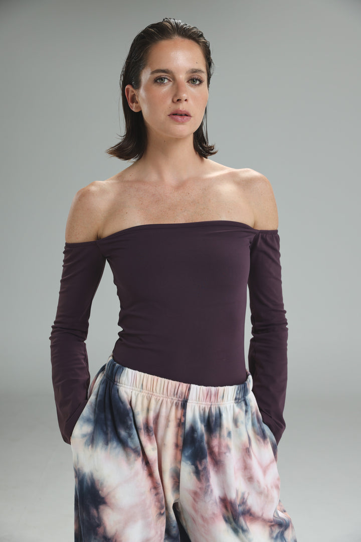 The model wears a deep purple lycra off shoulder top with long sleeves and a smooth, form fitting front view
