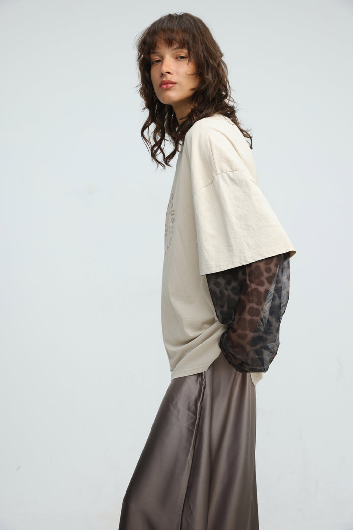 Beige oversized t-shirt with sheer leopard print layered sleeves shown from front view