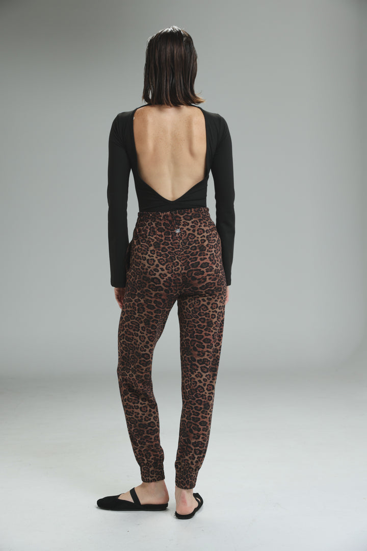 Lycra black open back bodysuit shown from the back paired with brown leopard print pants