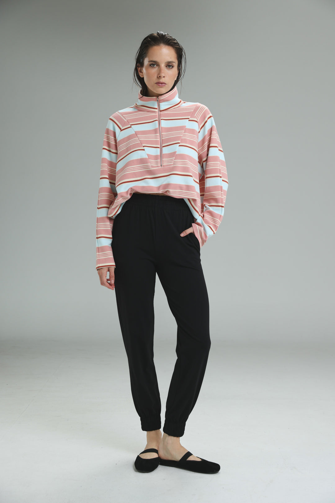 Soft pink and white striped half-zip sweatshirt with ribbed collar shown with bestie black joggers