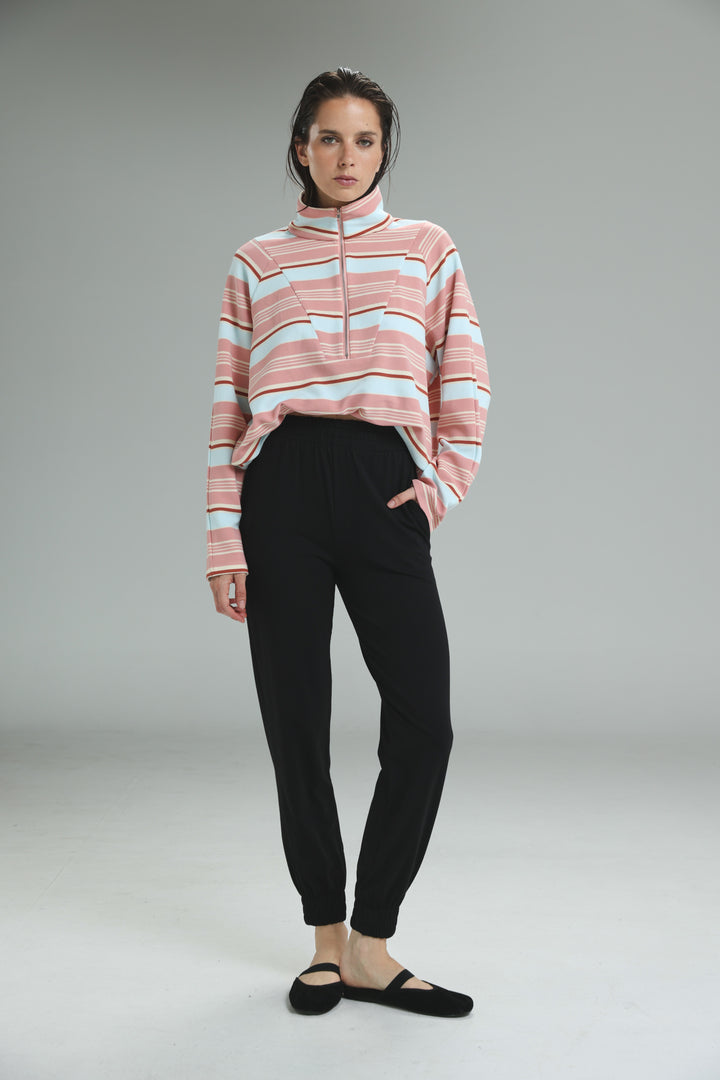 Soft pink and white striped half-zip sweatshirt with ribbed collar shown with bestie black joggers