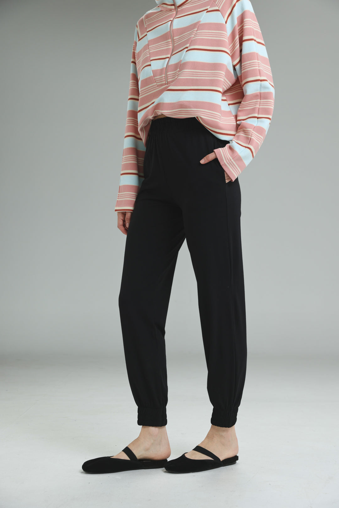 Black high-waisted jogger pants with elastic cuffs shown from the front in the bestie black joggers product image