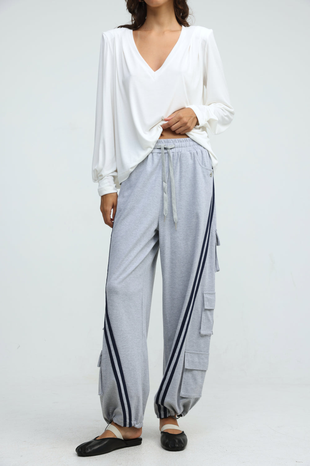 Light gray port grey joggers with black side stripes and multiple pockets shown from the front view