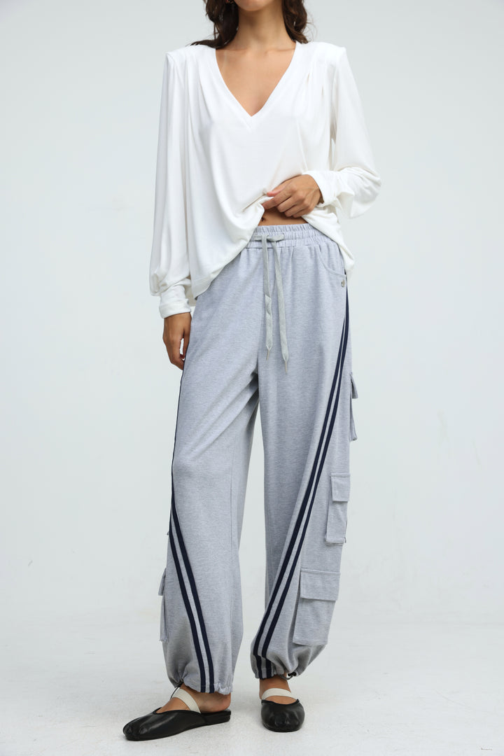 Light gray port grey joggers with black side stripes and multiple pockets shown from the front view