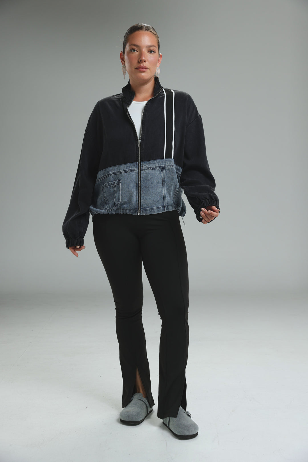 Soft denim panel jacket in black and blue denim patchwork with white zipper trim shown from the front