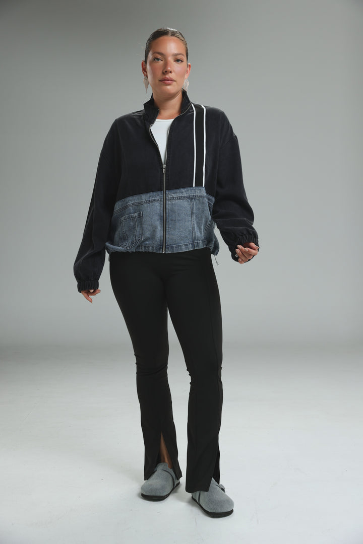 Soft denim panel jacket in black and blue denim patchwork with white zipper trim shown from the front