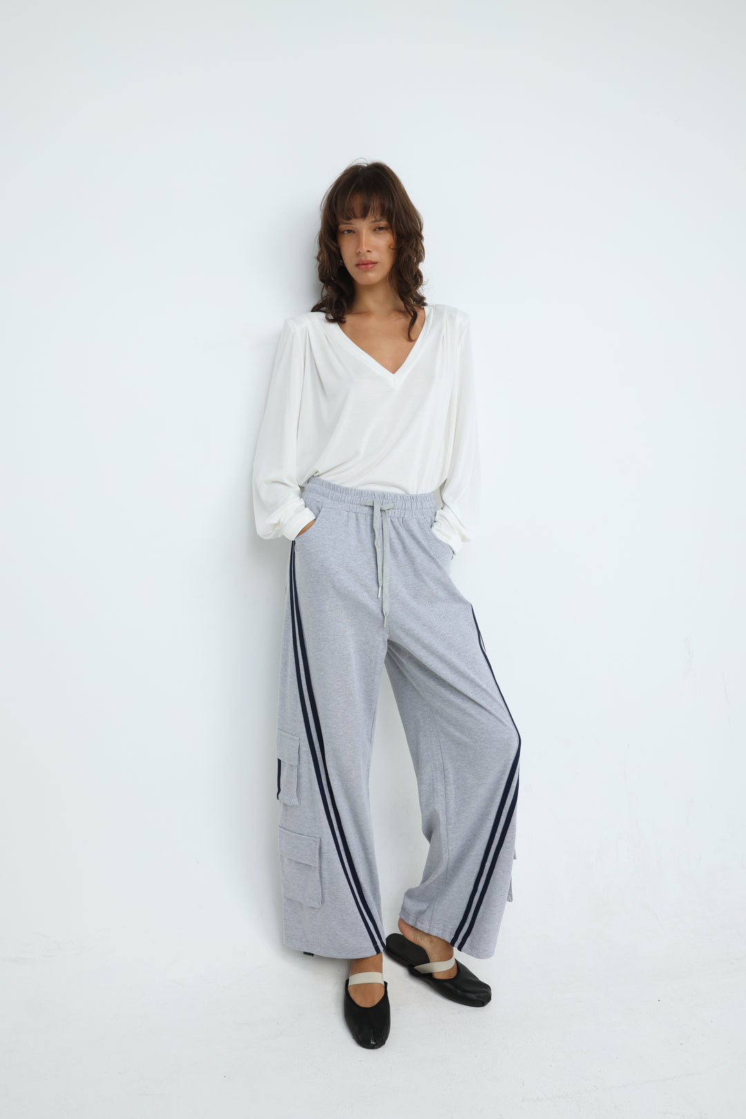 Light gray port grey joggers with wide-leg cut, black side stripes, and cargo pockets shown from the front