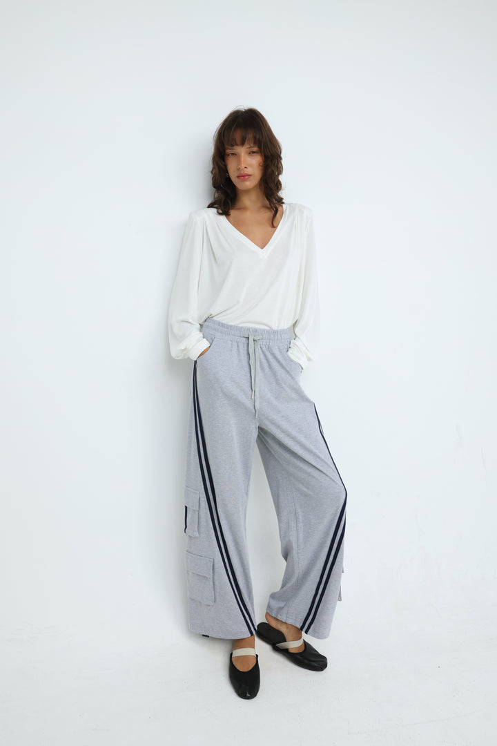 Light gray port grey joggers with wide-leg cut, black side stripes, and cargo pockets shown from the front