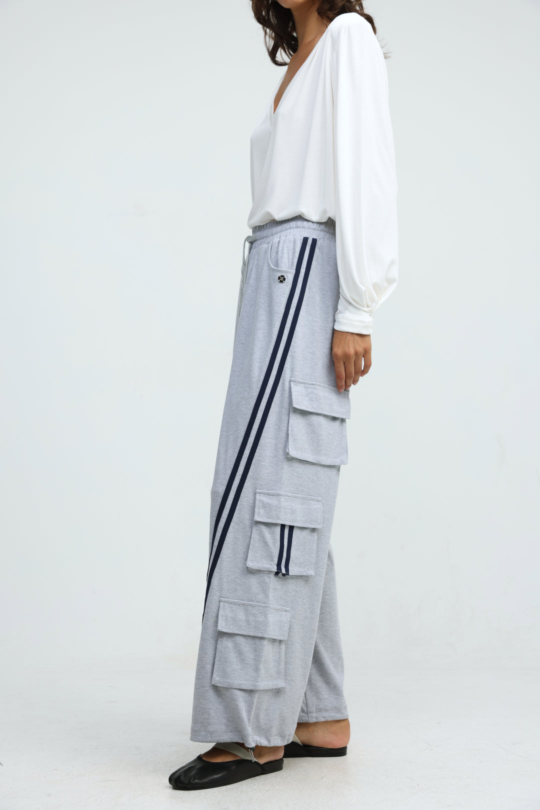 Port Grey joggers in light gray with bold black side stripes and large patch pockets shown from the front