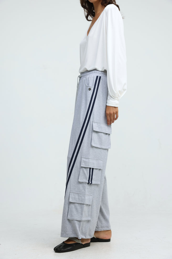 Port Grey joggers in light gray with bold black side stripes and large patch pockets shown from the front