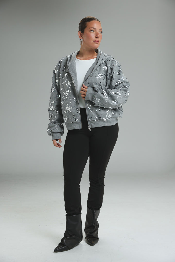 Fortune grey zip-up hoodie with scattered reflective sequins and soft textured fabric shown from the front