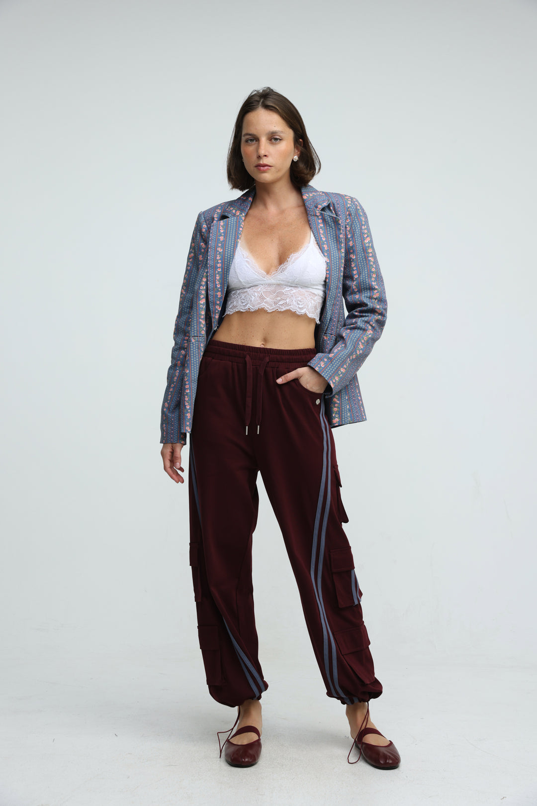 Maroon velour Port Wine joggers with side stripes and cargo pockets shown from the front view