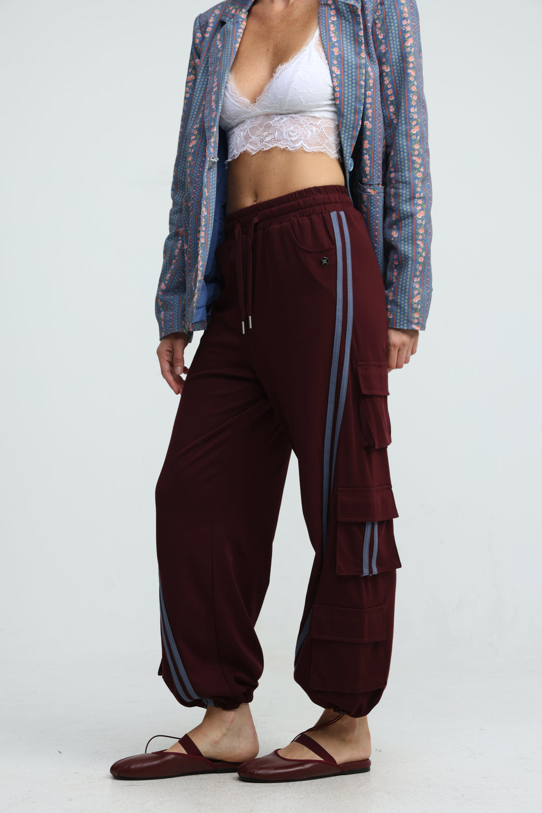 Port wine joggers in maroon with vertical striped side panels and tiered pocket detailing shown from the front