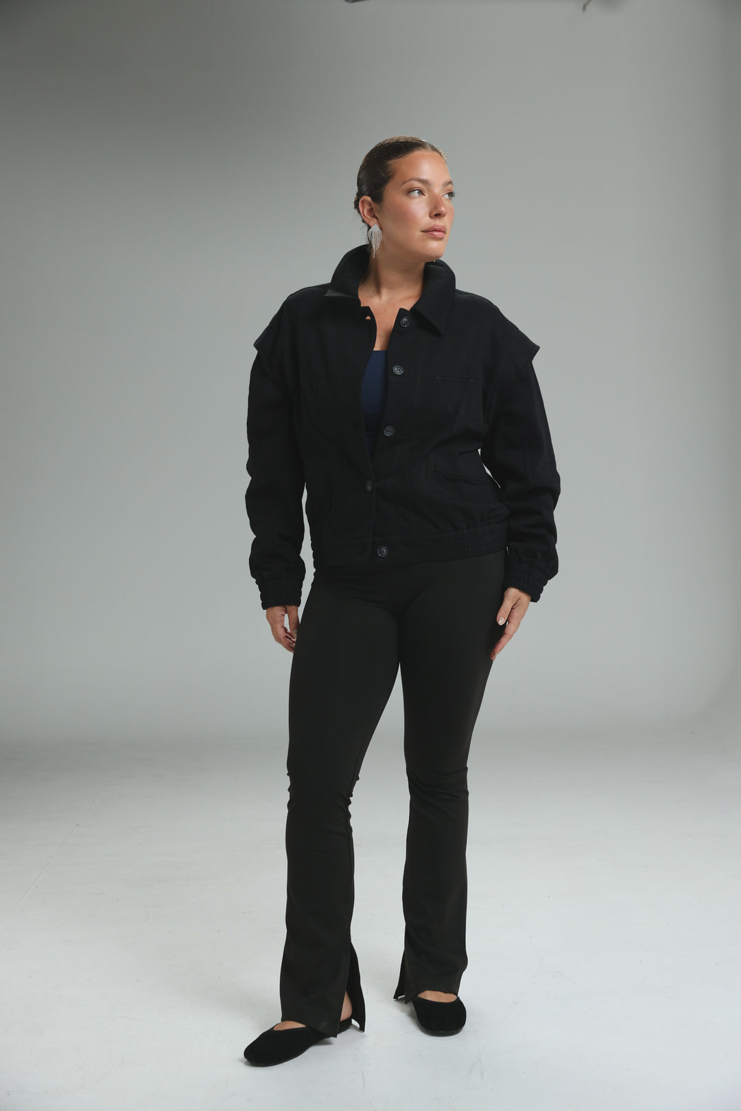 Black button-up Puzzle Wine jacket with high collar and flared sleeves shown from the front