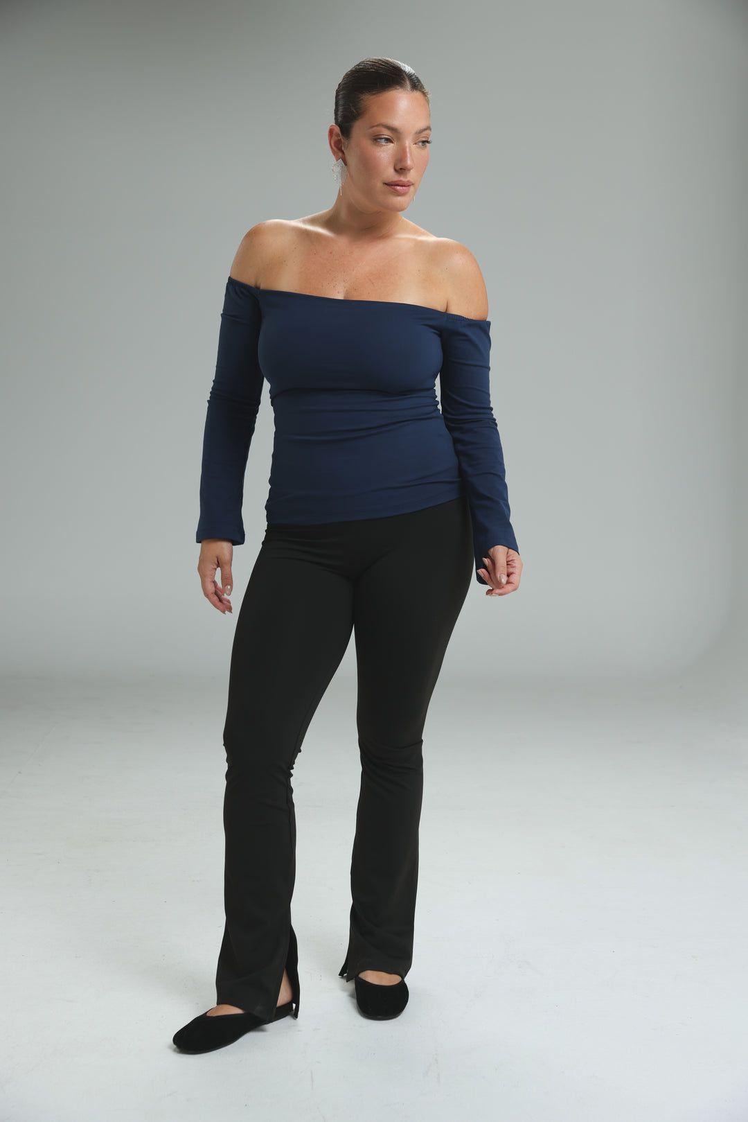 Lycra black off shoulder top with fitted silhouette and subtle ruching at the neckline shown from the front
