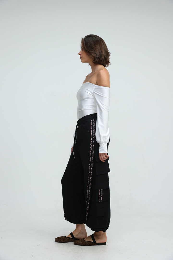 Port black joggers with black wide-leg pants featuring a side panel with silver-toned embroidery and patch pockets