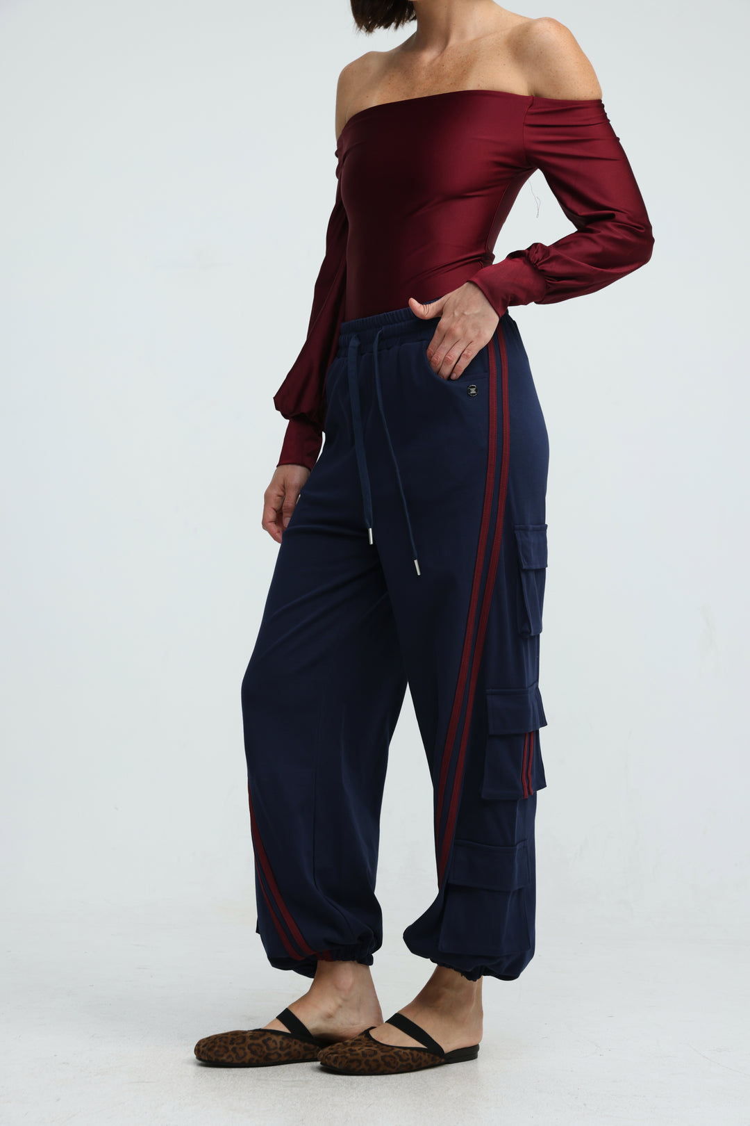 Navy blue cargo joggers with red side stripes and drawstring waistband shown from the front