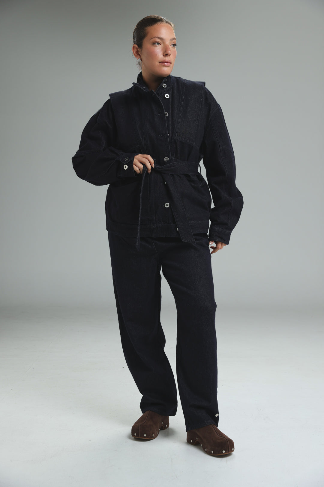 Prestige dark blue denim jacket with front button closures and belted waist shown from the front