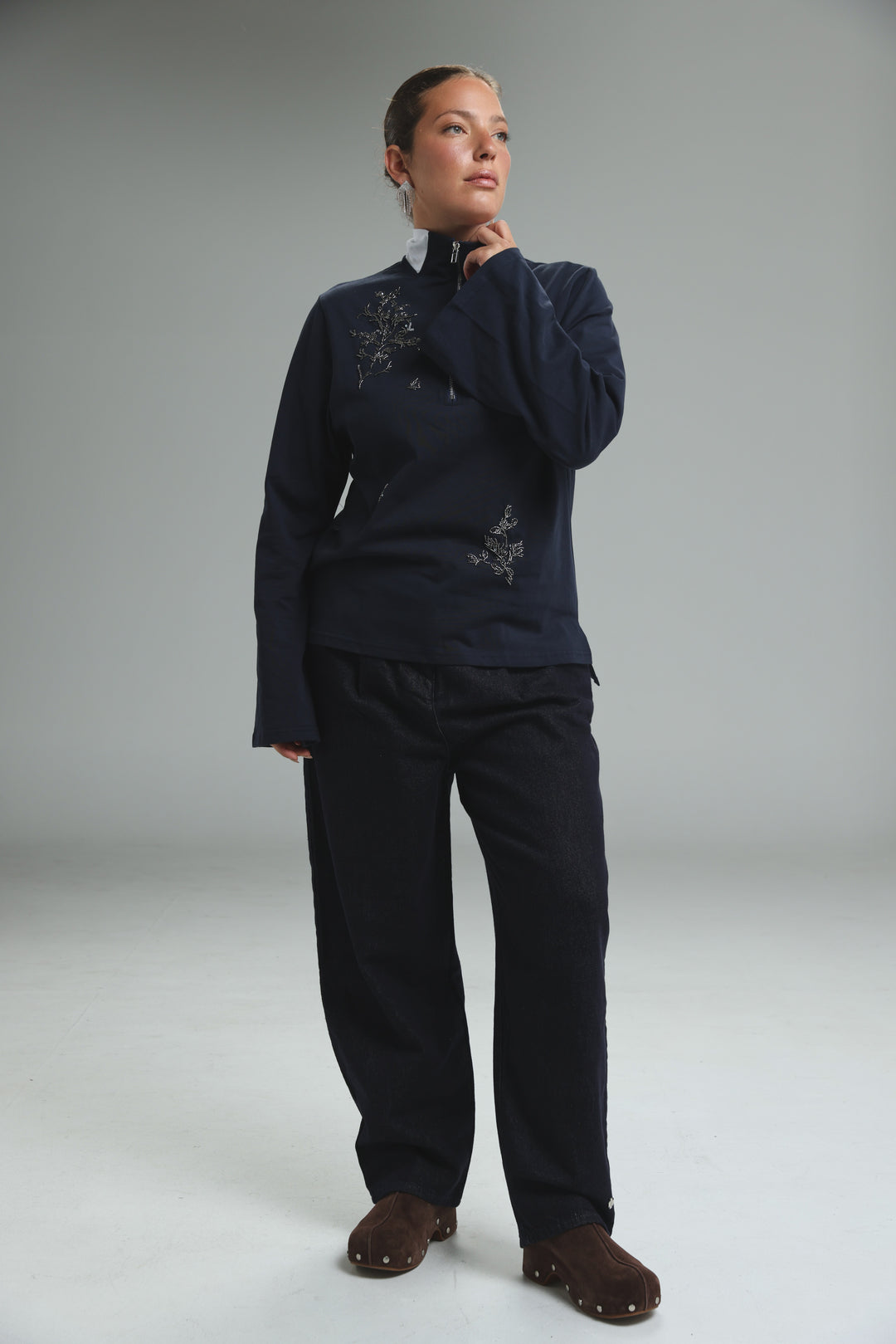 Navy blue Joy Navy Polo zip-up jacket with delicate silver floral embroidery shown from the front
