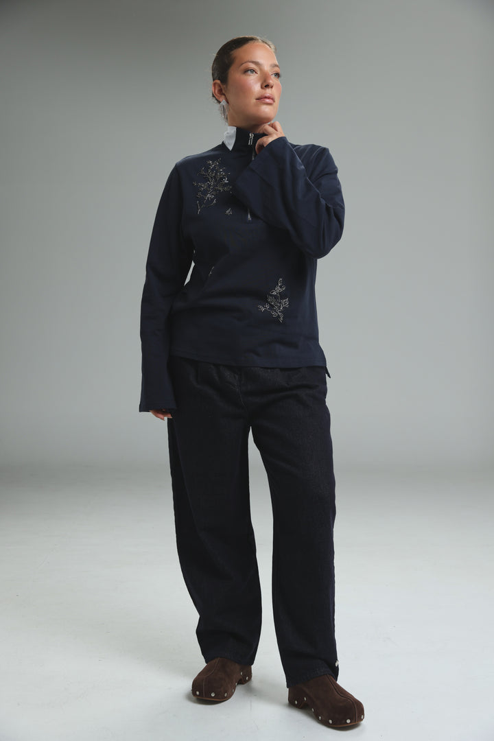 Navy blue Joy Navy Polo zip-up jacket with delicate silver floral embroidery shown from the front