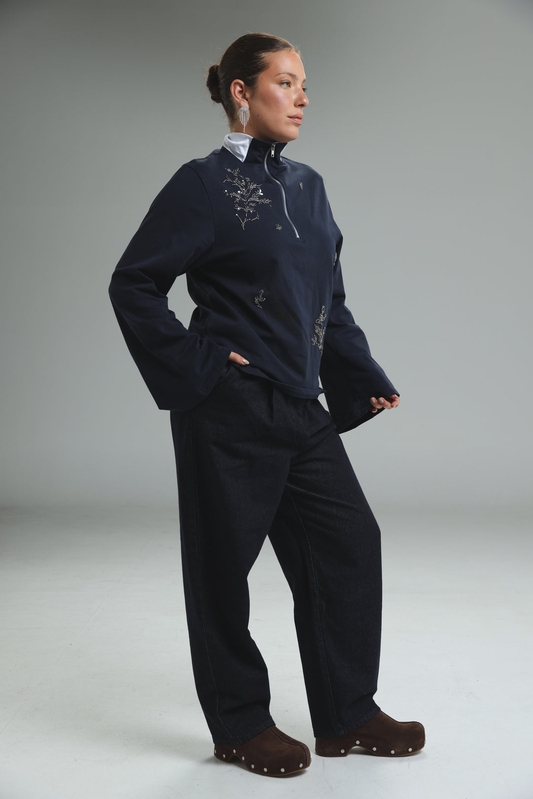 Navy blue zip-up jacket with silver floral embroidery and white collar shown from the front in Joy Grey Polo style