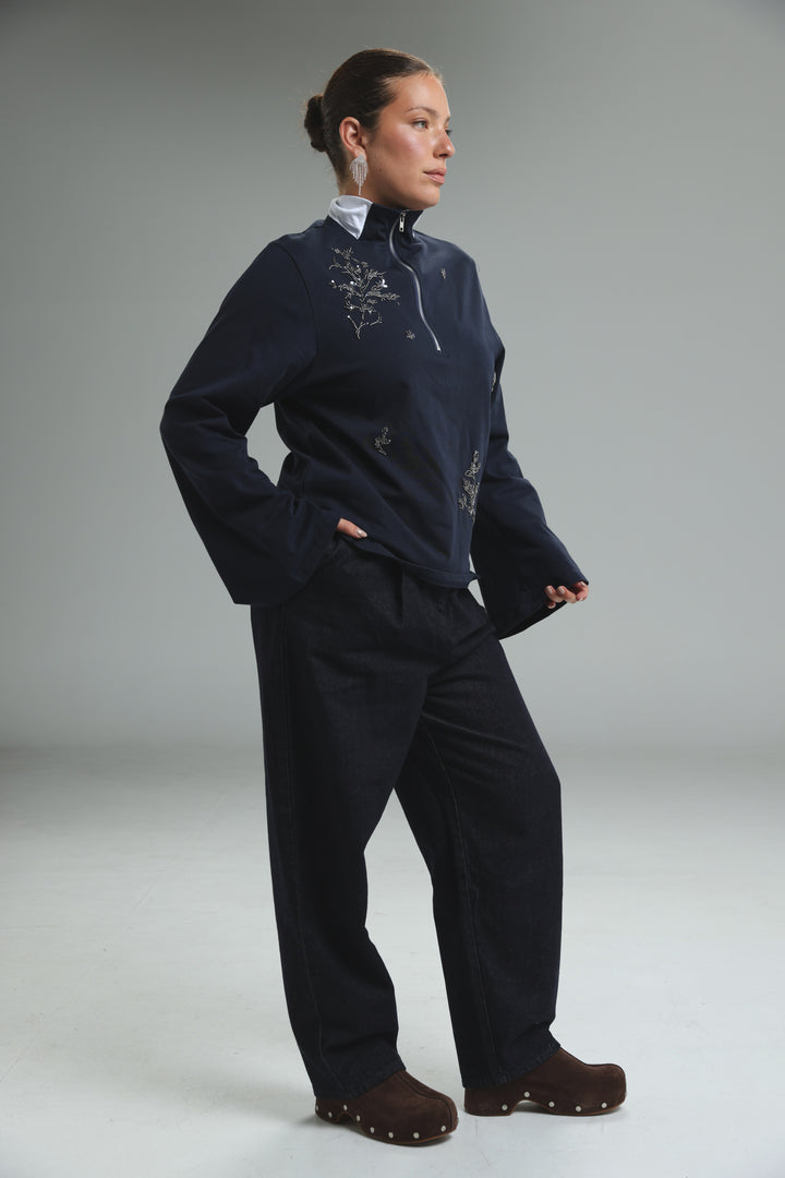 Navy blue zip-up jacket with silver floral embroidery and white collar shown from the front in Joy Grey Polo style