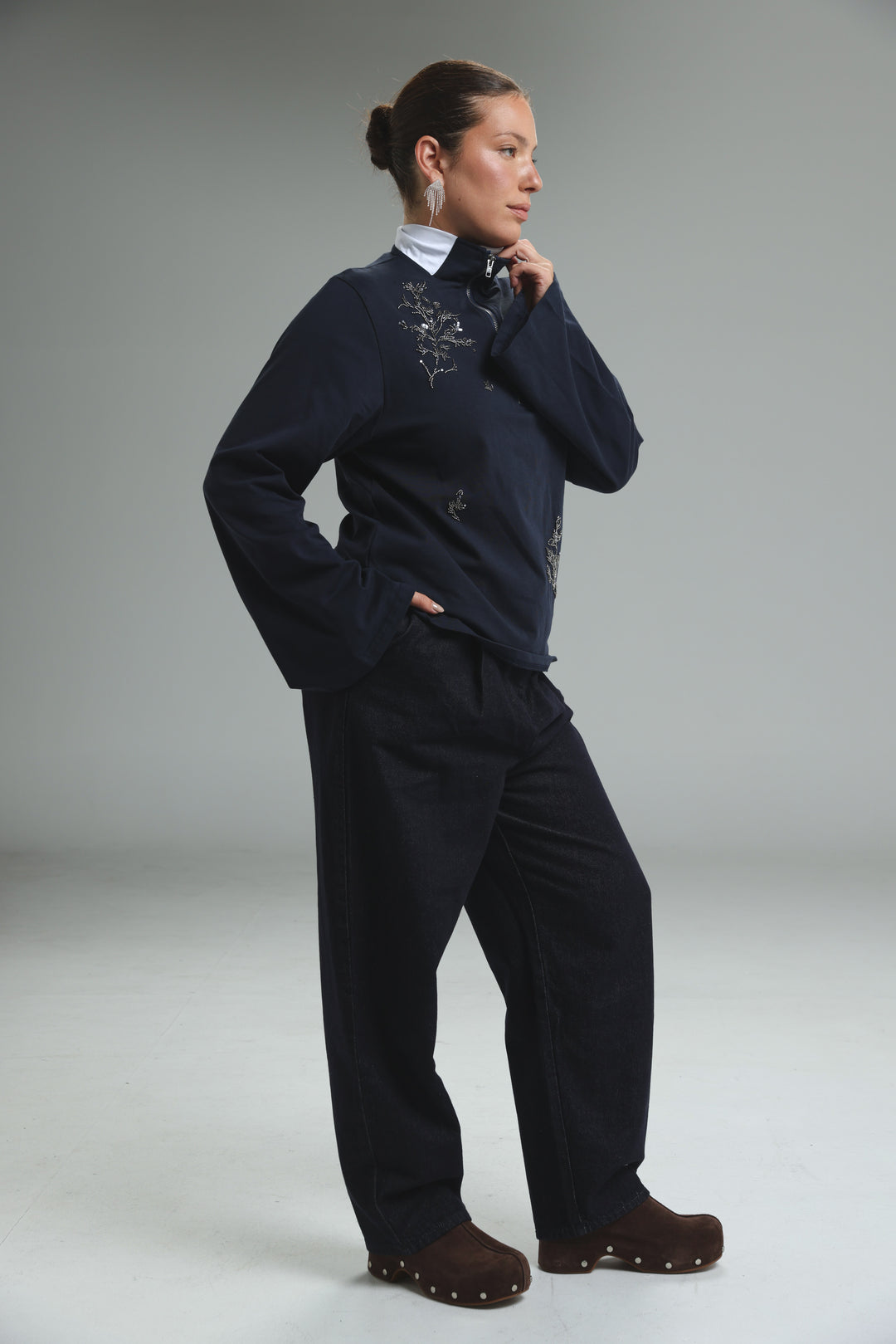 Navy blue zip-up jacket with delicate silver embroidery on the chest and sleeves shown from the front