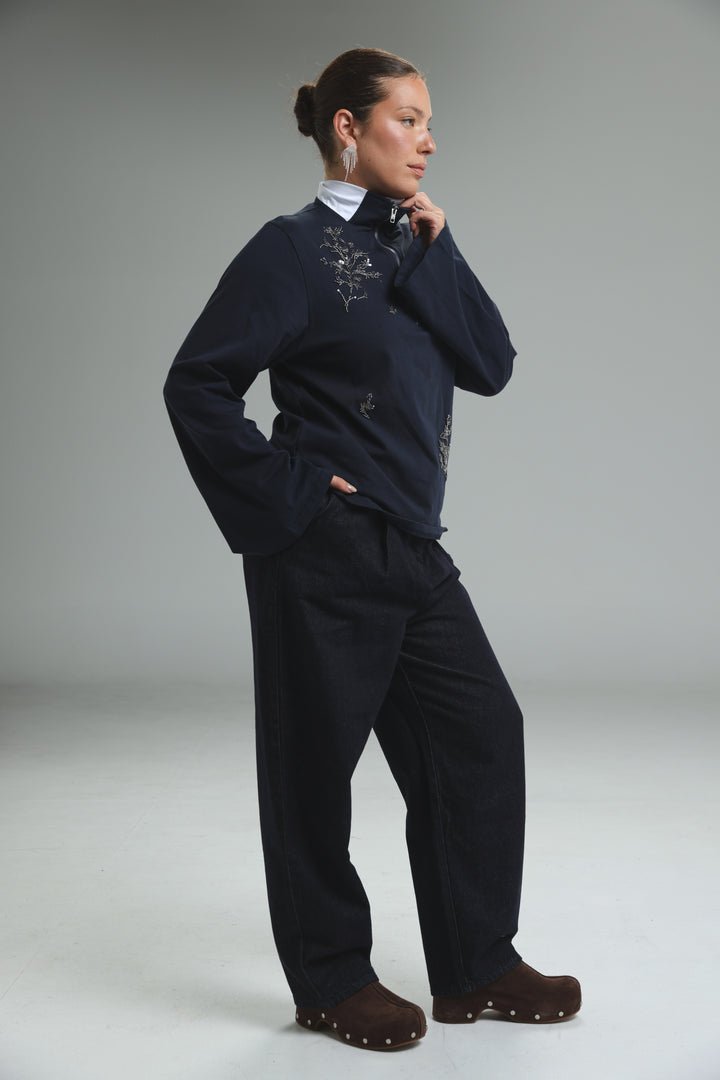 Navy blue zip-up jacket with delicate silver embroidery on the chest and sleeves shown from the front