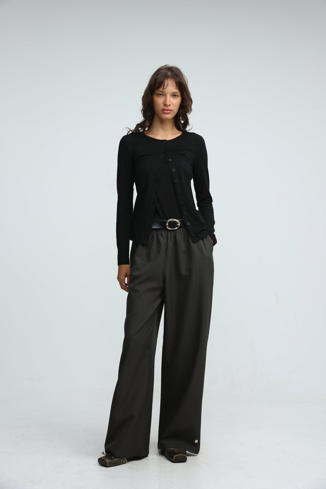 Black layered tank cardigan with long sleeves button-up front subtle textured knit and asymmetrical hemline front view