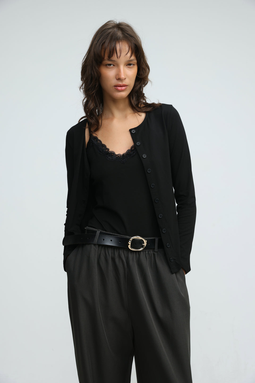 Black layered tank cardigan front view with black button-up style and delicate lace trim at the neckline