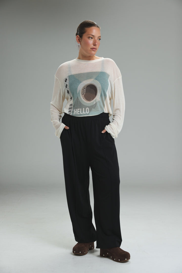 White long-sleeved Hello Coffee cream shirt with light blue graphic print of hello and coffee cup on the front