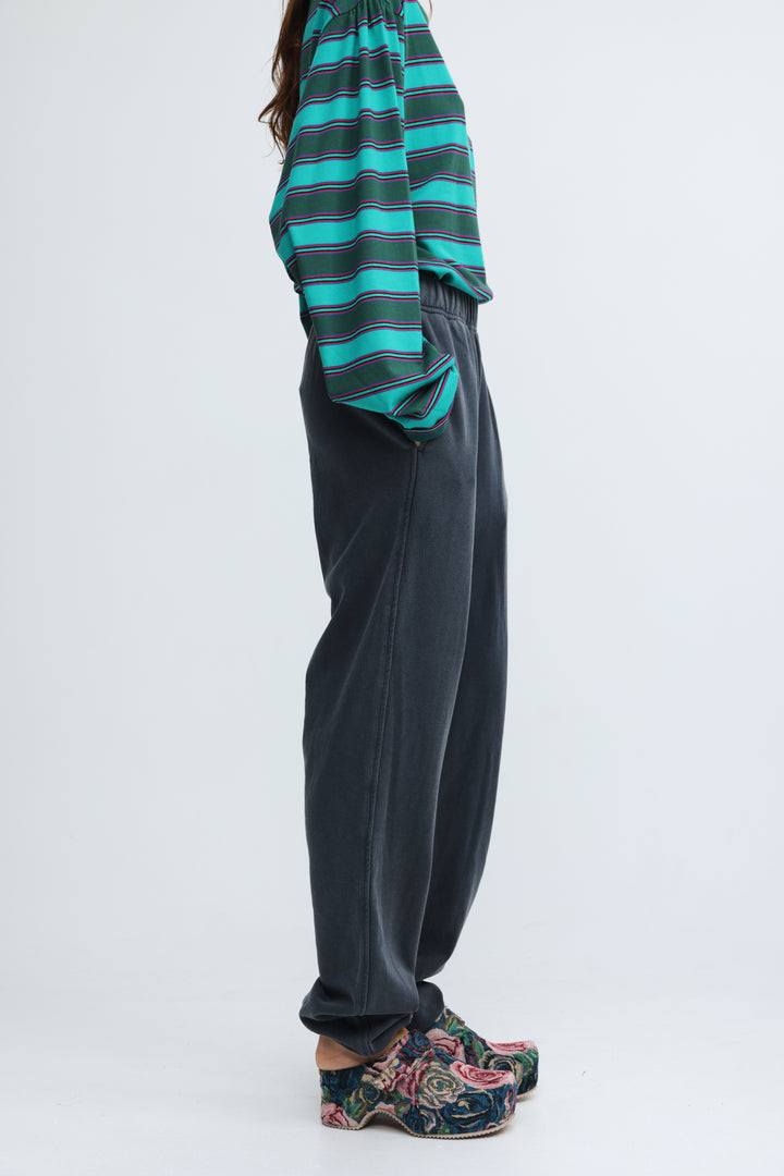 Dark gray wide-leg trousers with soft texture and elastic waistband shown from the front labeled zone dark blue joggers