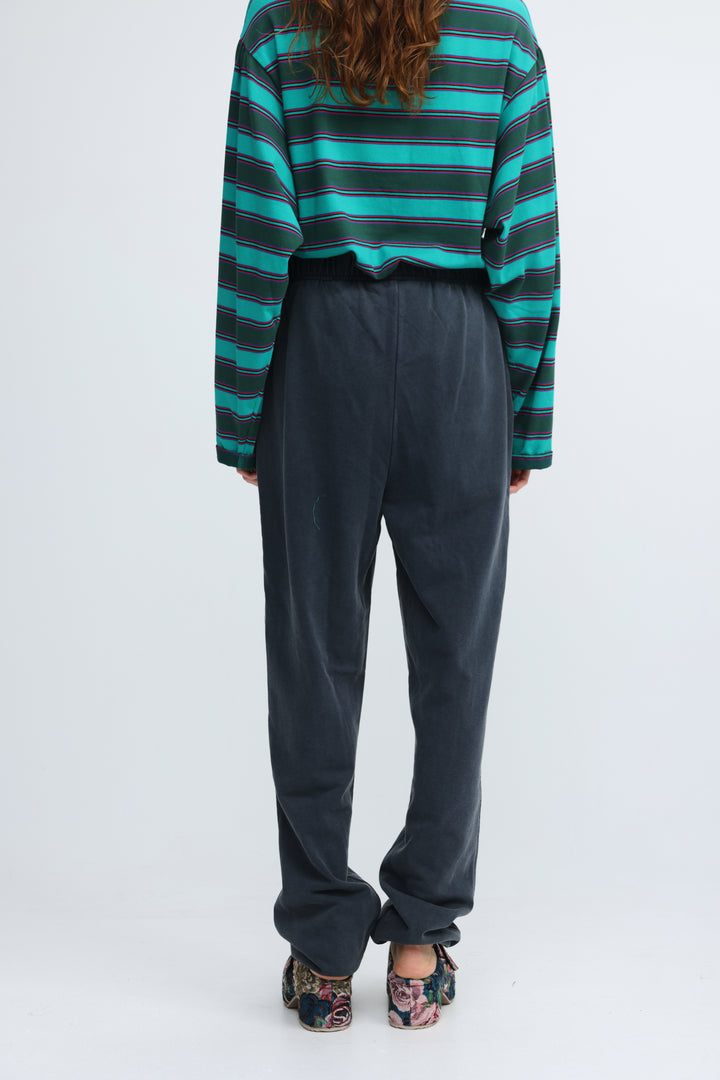 Dark blue joggers with a relaxed fit, high waist, and cuffed hems shown from the front view