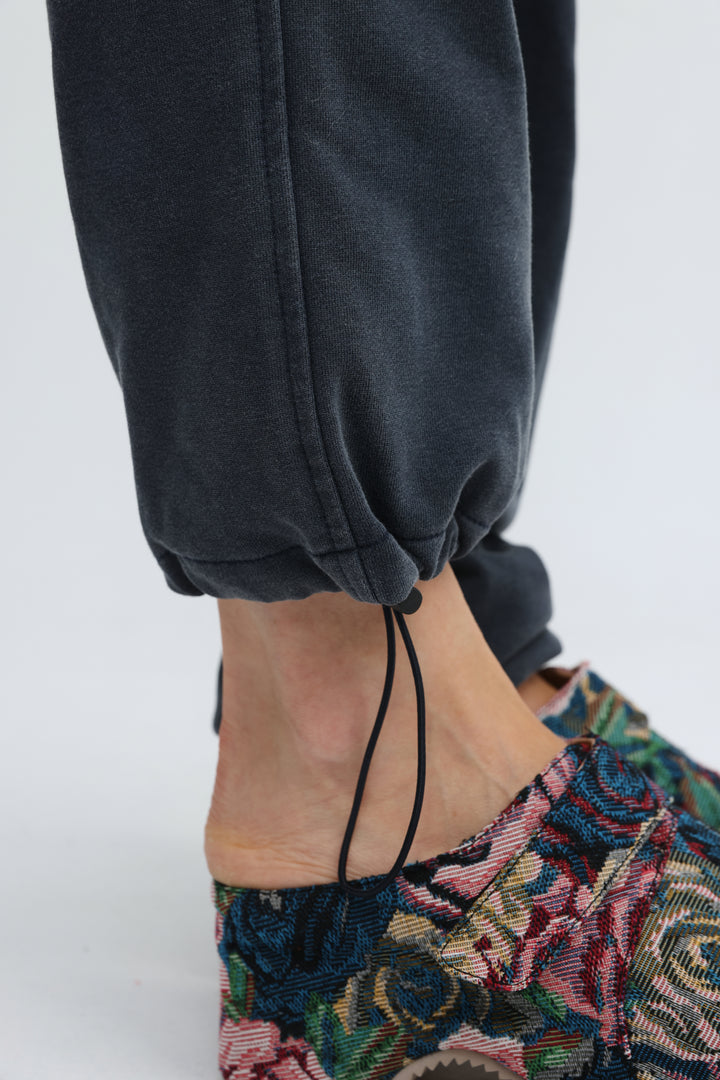 Zone dark blue joggers shown front view in dark gray with drawstring cuff and relaxed fit silhouette