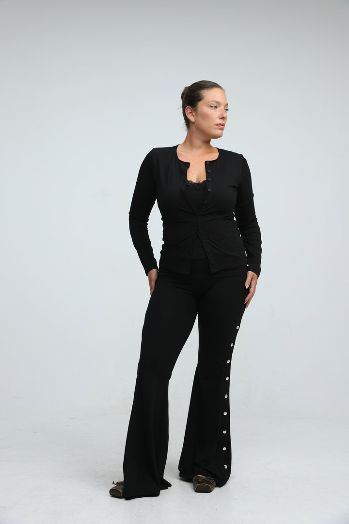 Black layered tank cardigan with long-sleeved button-up top ruched at waist and matching flared pants with silver buttons