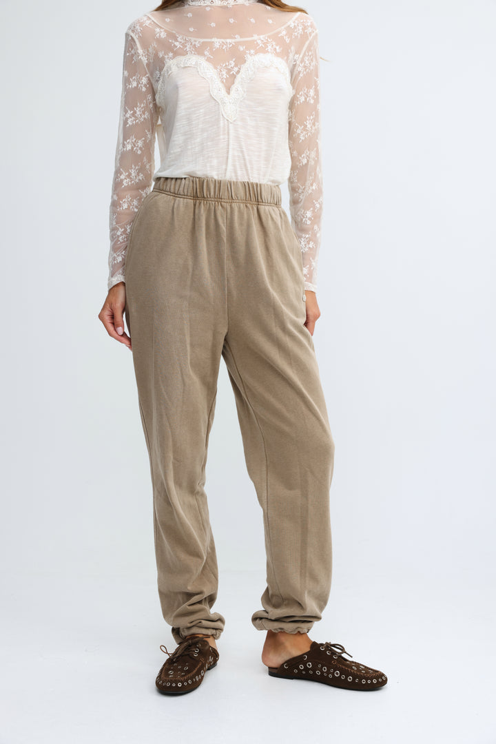 Beige high-waisted Zone camel joggers with elastic waistband and cuffed ankles shown from the front