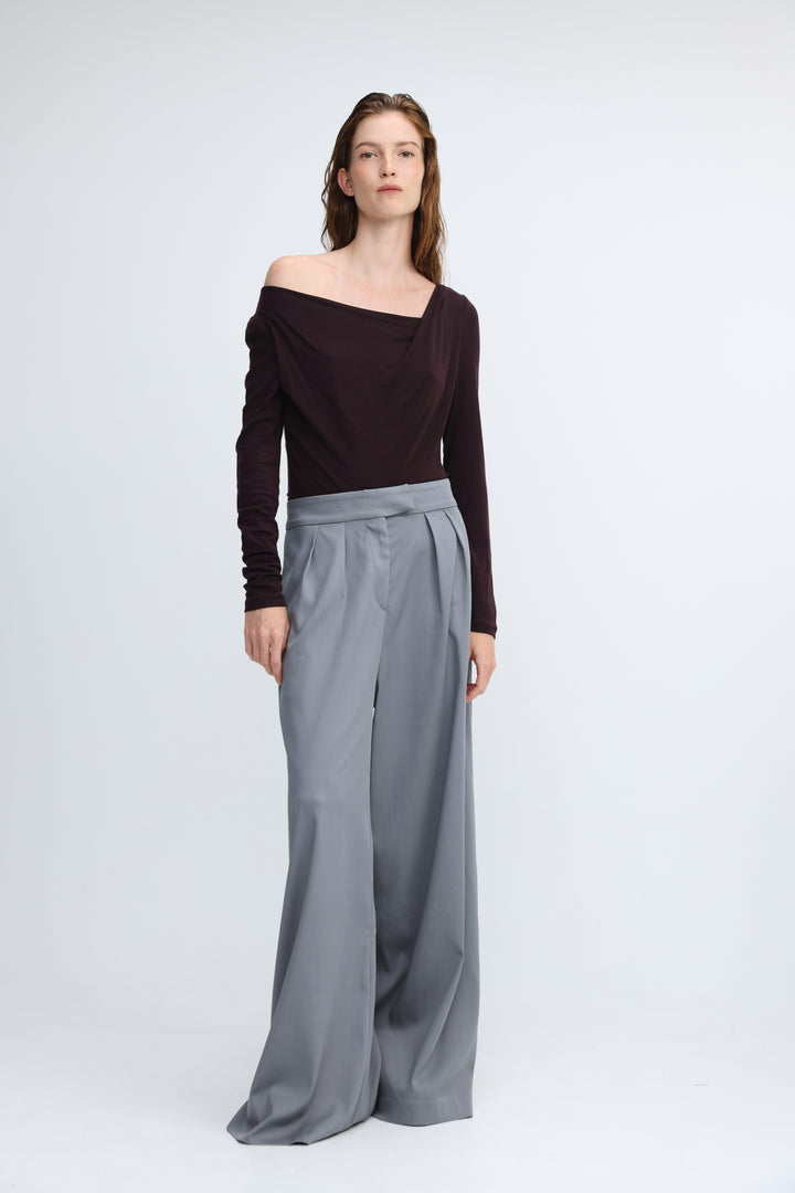 Miss purple shirt featuring a sleek off-the-shoulder dark burgundy top and high-waisted gray pleated wide-leg pants front view