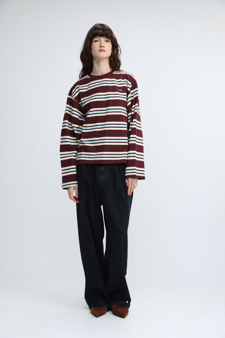 Front view of a maroon and white striped long-sleeved sweater with a small embroidered patch on the chest